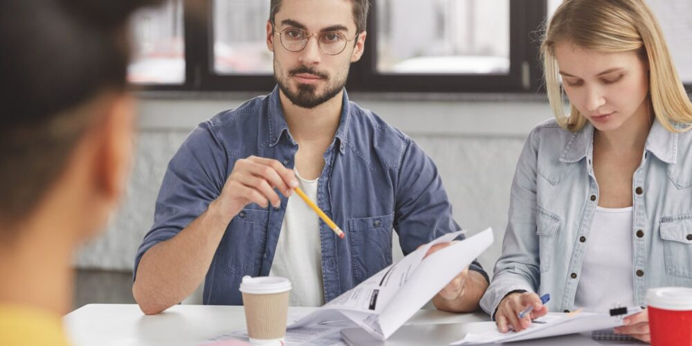 young-colleagues-have-formal-meeting-discuss-solutions-study-documents-prepare-marketing-project-.jpg